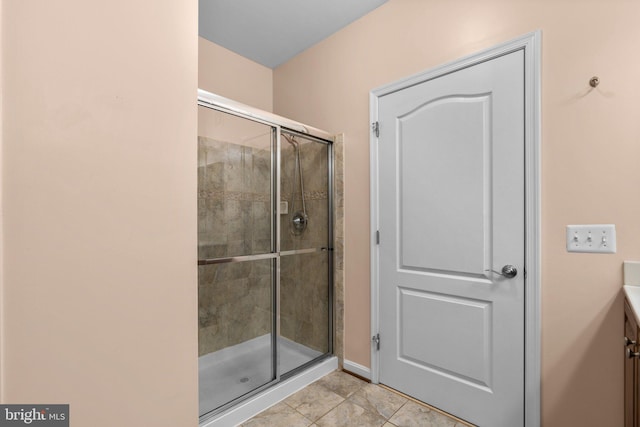 bathroom with vanity, tile patterned floors, and a shower with door