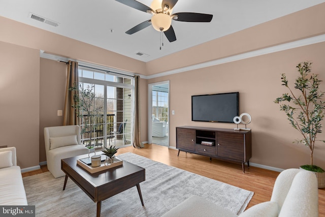 living room featuring ceiling fan and light hardwood / wood-style flooring