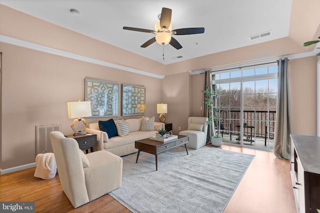 living room with light hardwood / wood-style floors and ceiling fan