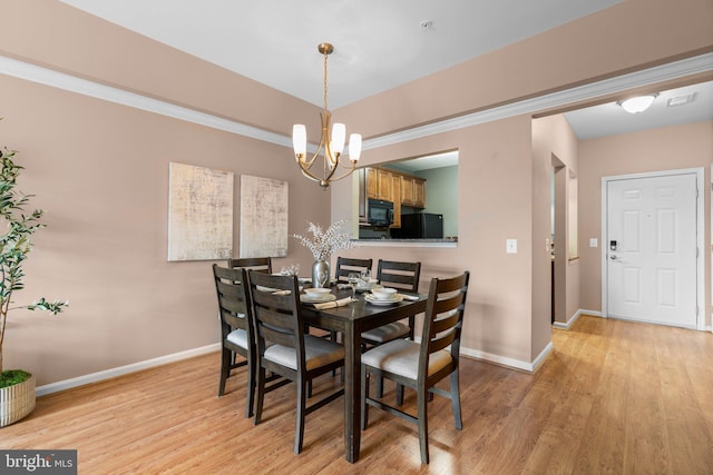 dining area featuring a chandelier and light hardwood / wood-style floors