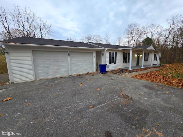 single story home with covered porch and a garage