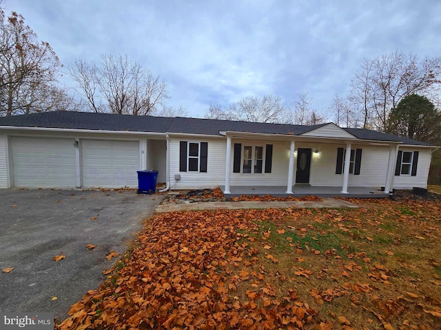 single story home with covered porch and a garage