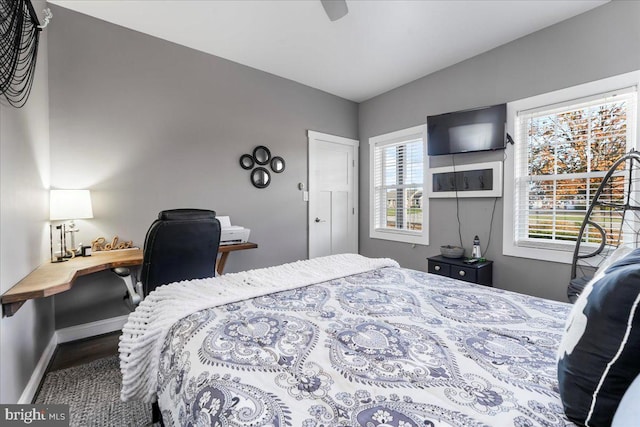 bedroom featuring ceiling fan and lofted ceiling