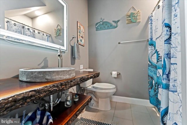 bathroom with tile patterned floors, sink, and toilet