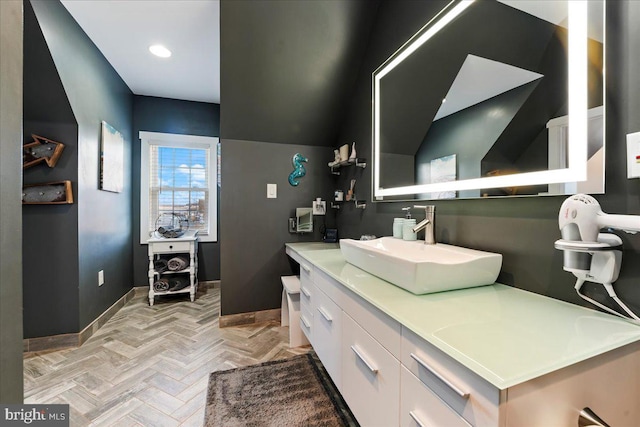 bathroom with vanity and parquet floors