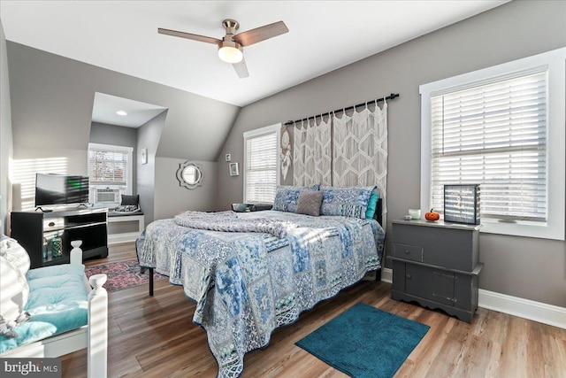 bedroom featuring ceiling fan, vaulted ceiling, and hardwood / wood-style flooring