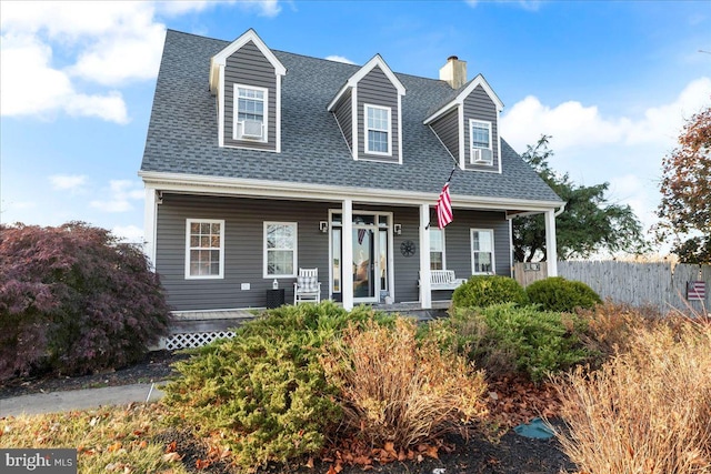 cape cod home featuring a porch