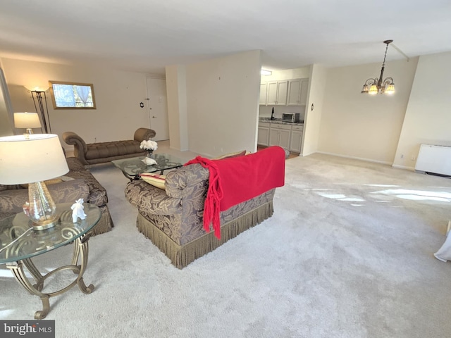 carpeted living room featuring a chandelier