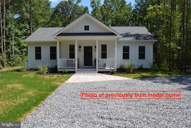 view of front of home with a porch and a front lawn