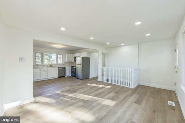 interior space featuring sink and light hardwood / wood-style flooring