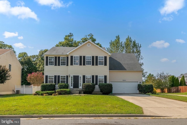 colonial house featuring central AC unit, a garage, and a front lawn