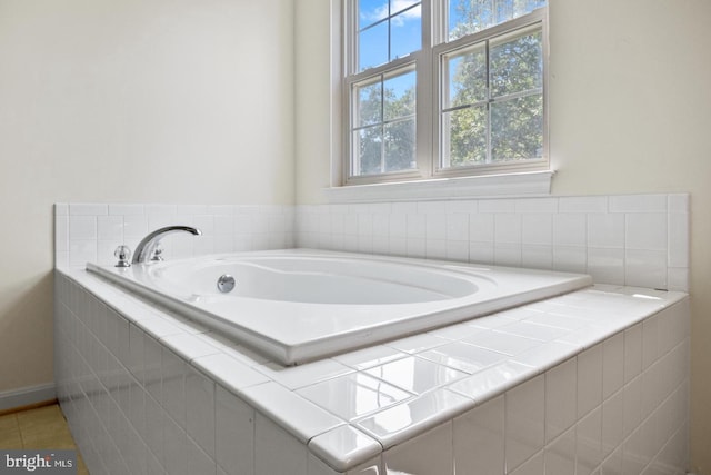 bathroom featuring tile patterned floors and tiled tub