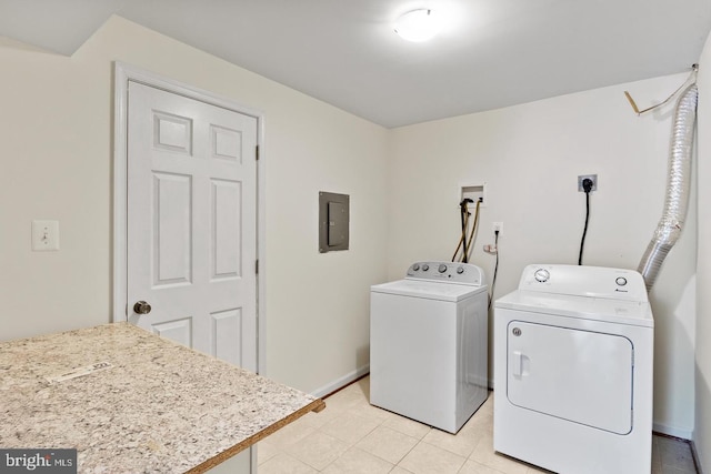 clothes washing area featuring washing machine and dryer, electric panel, and light tile patterned flooring