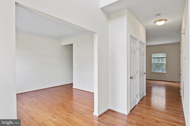 hall featuring ornamental molding and hardwood / wood-style flooring