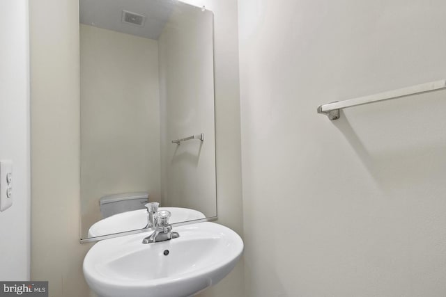 bathroom featuring sink and toilet