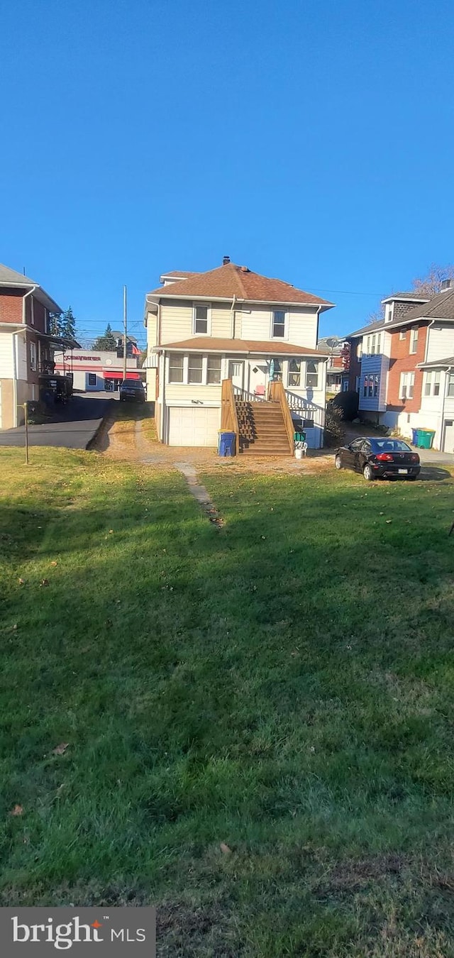 rear view of house with a yard