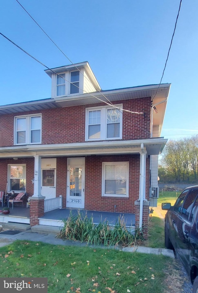 townhome / multi-family property with a porch