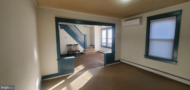 carpeted spare room with a wall mounted AC and baseboard heating