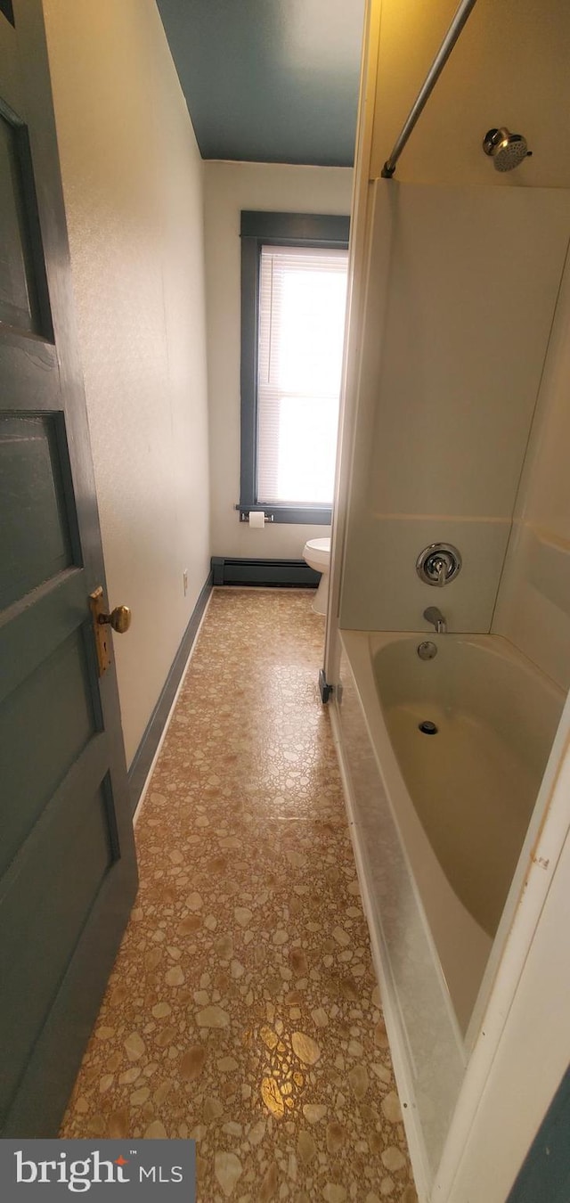 bathroom featuring shower / bath combination and toilet