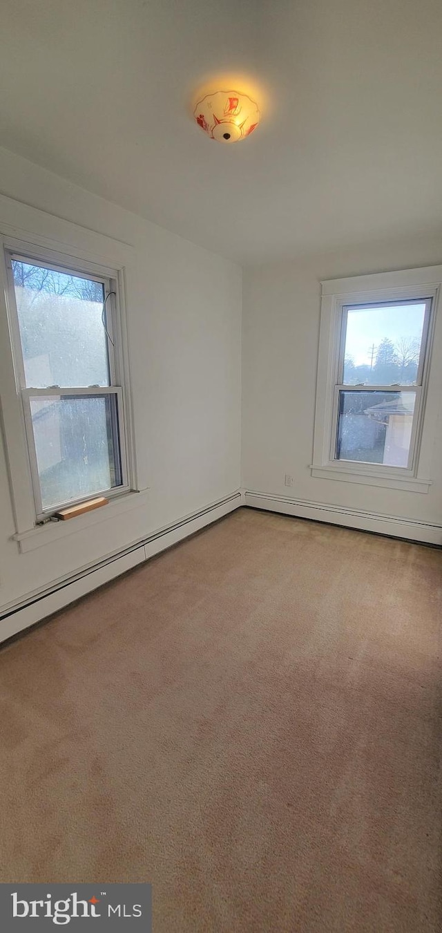 unfurnished room with carpet and a wealth of natural light