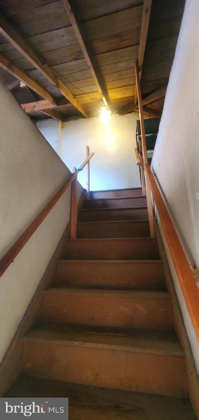 staircase with wood ceiling