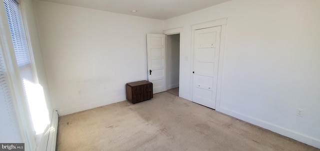 unfurnished bedroom with light carpet and multiple windows