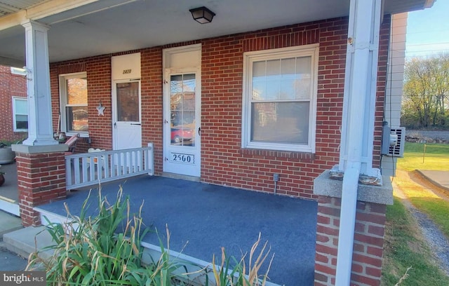 view of exterior entry with covered porch