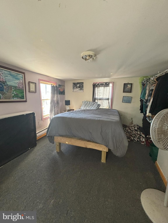 bedroom featuring carpet flooring and a baseboard heating unit