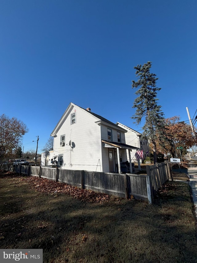 view of property exterior with a lawn