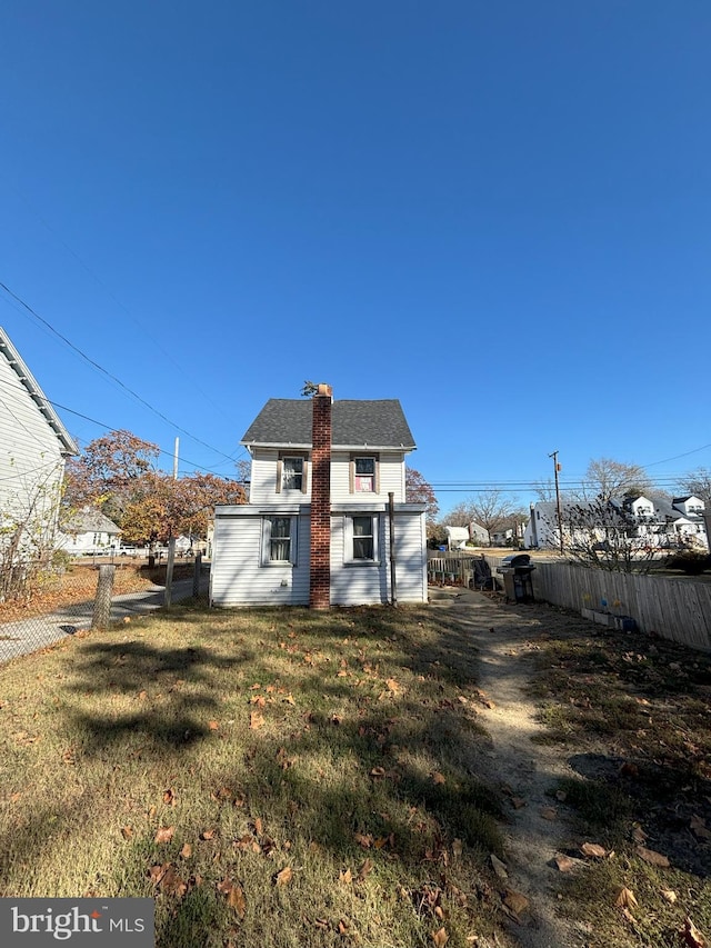 back of property featuring a yard