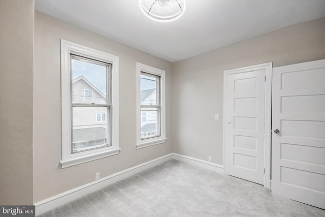 unfurnished room with light colored carpet