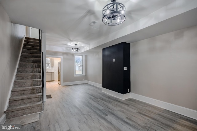 interior space featuring light hardwood / wood-style floors and an inviting chandelier