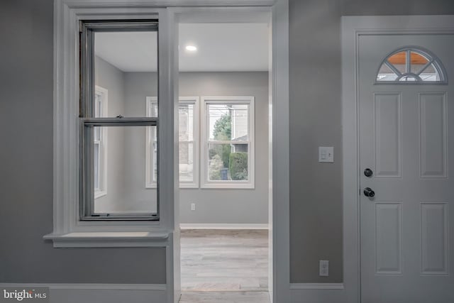 entryway with hardwood / wood-style floors