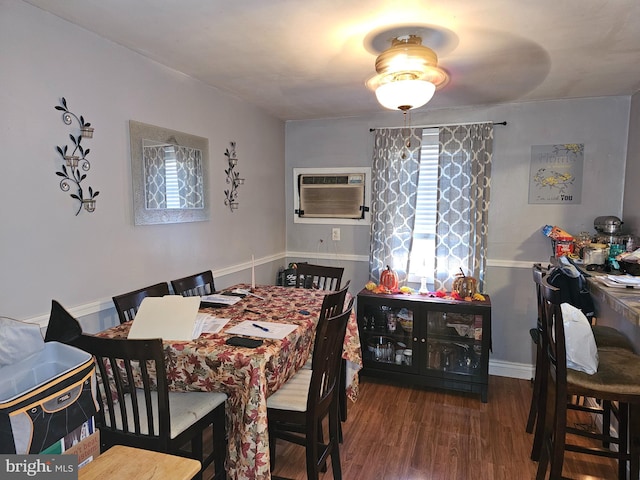 dining area with dark wood-type flooring and a wall unit AC