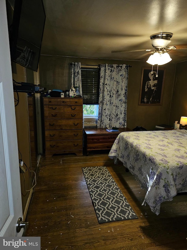 bedroom featuring ceiling fan and dark wood-type flooring