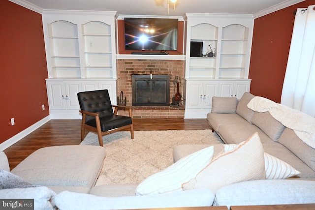 living room with a fireplace, built in shelves, dark hardwood / wood-style floors, and crown molding