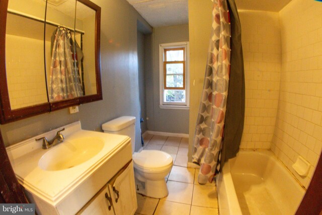 full bathroom with tile patterned floors, shower / bath combination with curtain, toilet, and vanity