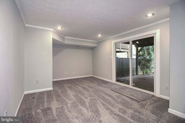 unfurnished room with carpet, a textured ceiling, and ornamental molding