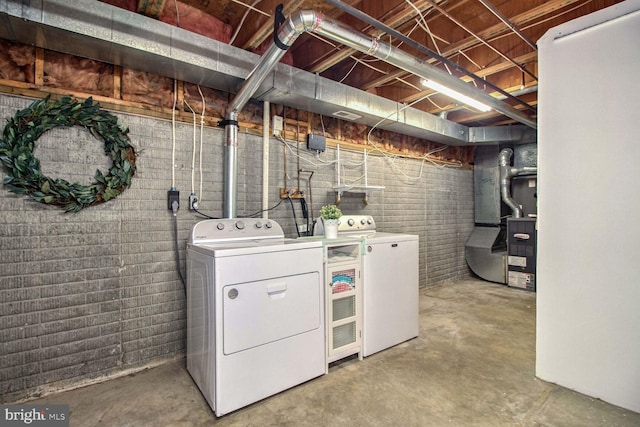 clothes washing area with heating unit and washer and clothes dryer