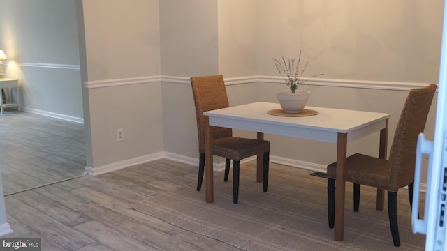 dining space with hardwood / wood-style flooring