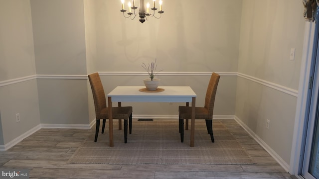 dining area featuring a chandelier and hardwood / wood-style flooring