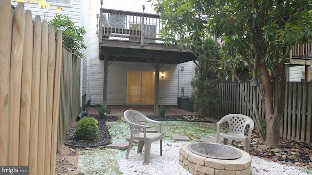 view of patio with a deck and an outdoor fire pit