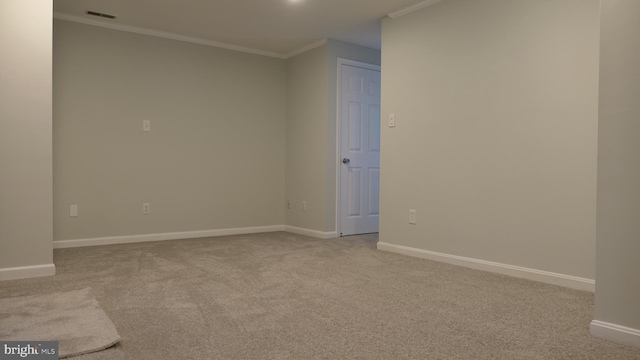 carpeted spare room with crown molding