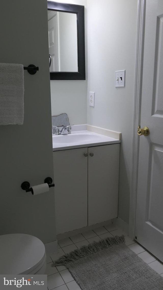 bathroom with tile patterned floors, vanity, and toilet