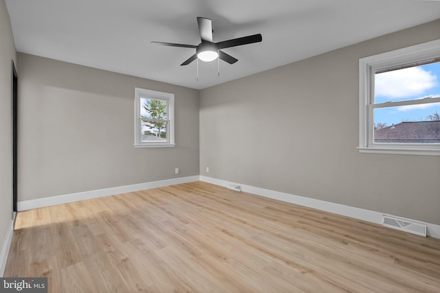 empty room with light hardwood / wood-style floors and ceiling fan