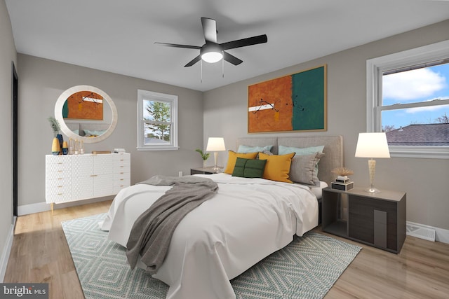 bedroom with light wood-type flooring and ceiling fan