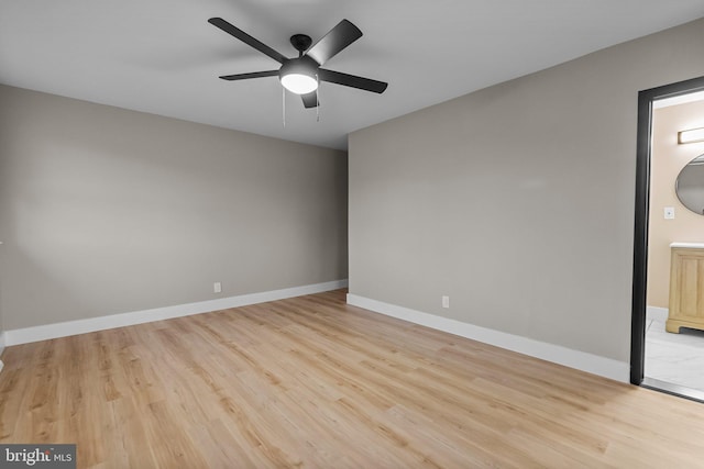 empty room with ceiling fan and light hardwood / wood-style floors