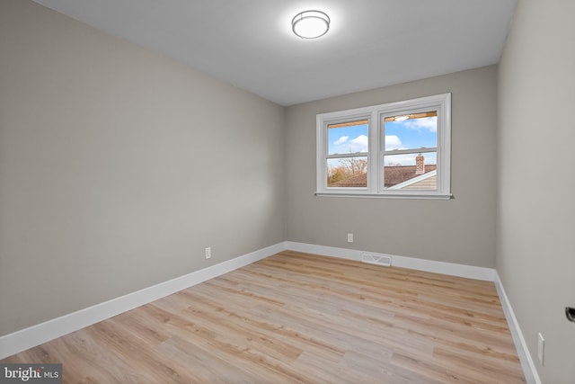 spare room with light hardwood / wood-style floors