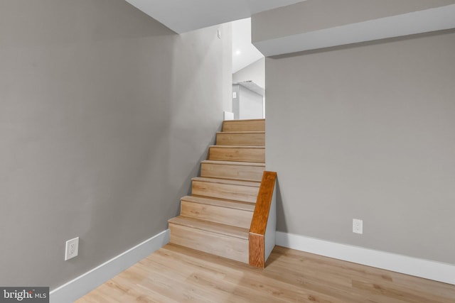 stairway featuring hardwood / wood-style floors