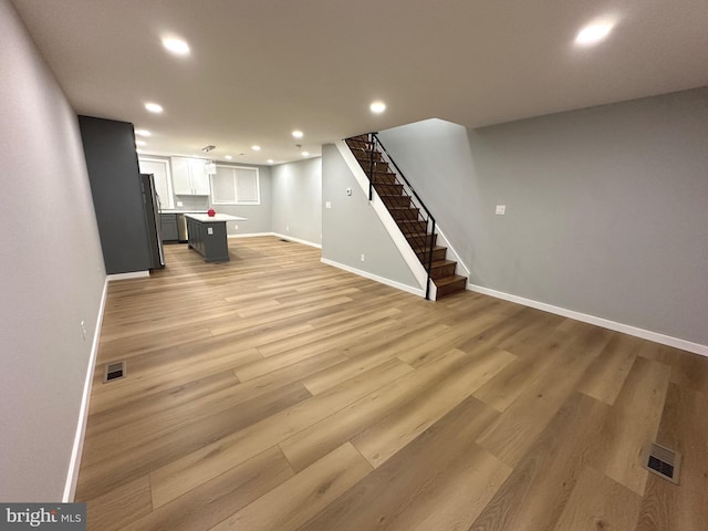 unfurnished living room with light hardwood / wood-style flooring